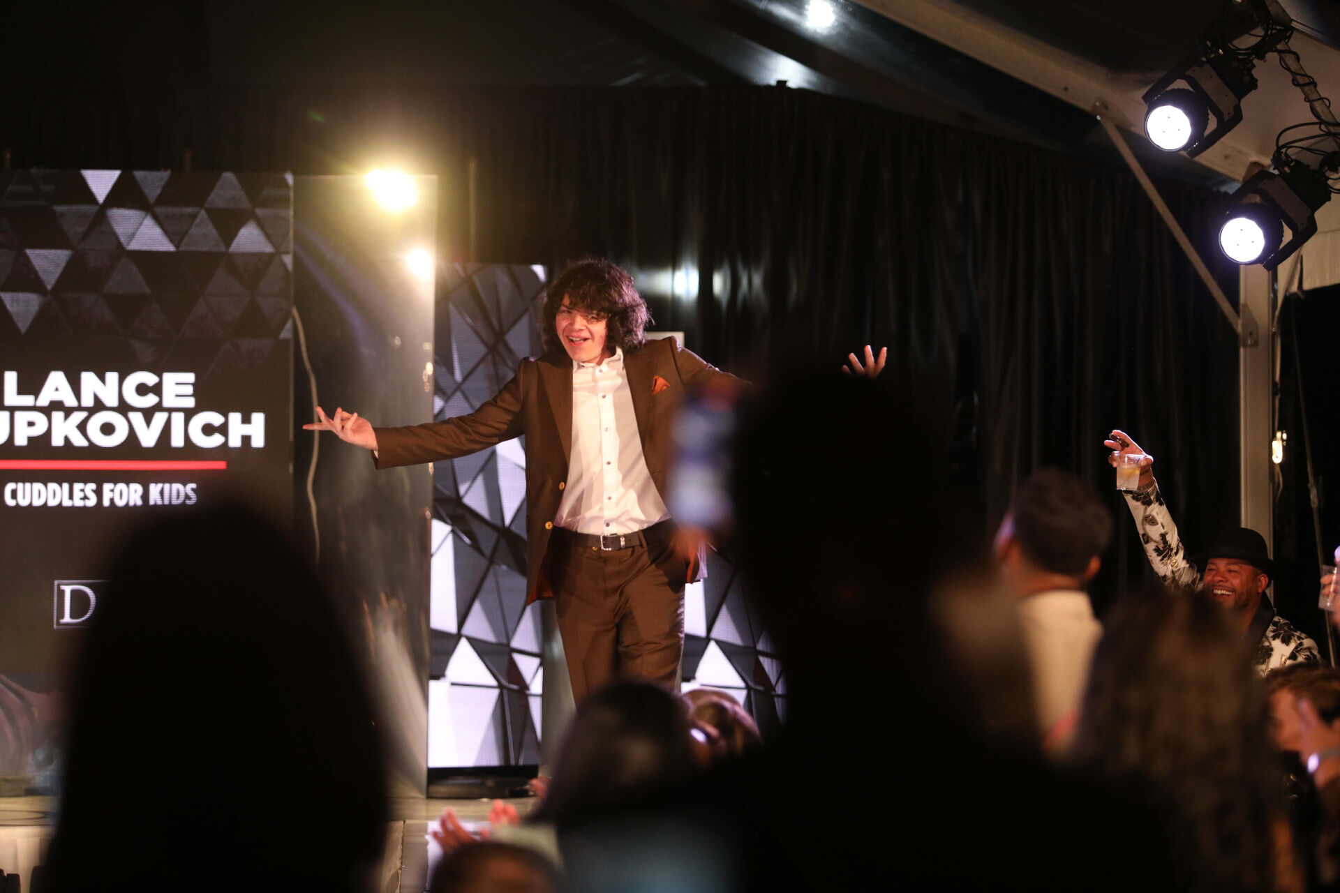 Lance Jupkovich on stage at a David Alan Dreams charity fashion show